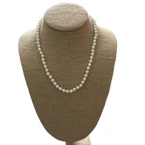 Vintage Talbots string of white pearls with gold toned box clasp.